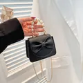 Mini black crossbody bag with bow detail, pearl handle and golden chain strap - Black
