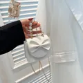 Mini white leather crossbody bag with elegant bow, pearl handle and gold chain strap - White