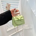 Mini light green crossbody bag with a large bow, pearl handle, and golden chain strap - Khaki
