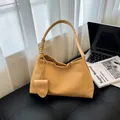 Woven bright yellow bucket bag with textured pattern and matching small pendant charm - Khaki