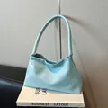 Light blue woven shoulder bag with minimalist cross-stitch texture and soft faux leather - Blue