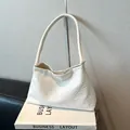 Chic white woven shoulder bag for women with minimalist hobo style design and texture - White