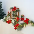 Primer plano de corona de Navidad iluminada con agujas de pino, flores rojas y piñas - Estándar Sin Luces / Longitud Estándar