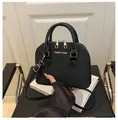Detail of black crocodile texture shell bag with silver metallic Fashion & Bags logo - Black
