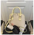Detail of woven texture and metal double zipper on stylish beige shell bag - Yellow