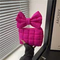 Quilted rose pink puffy handbag featuring a large bow handle and square stitching texture - Rose Pink
