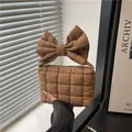 Quilted caramel brown handbag with oversized bow handle and soft padded texture - Khaki