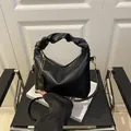 Minimalist black pleated hobo bag with cloud-style handle and golden zipper detail - Black