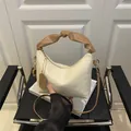 Chic pleated crossbody bag in creamy white with stylish brown twisted top handle - Off White