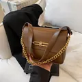 Stylish minimalist brown leather chain handbag with elegant gold metal clasp detail - Brown