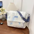 Cream canvas messenger bag with blue butterfly and calligraphy prints and wide strap - Blue