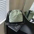 Sage green nylon drawstring bucket bag with adjustable strap and fashion embroidery - Green