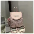 Close-up of pink mini backpack with IBCMB embroidery and plush bear keychain - Pink With Pendant