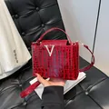 Chic red crocodile pattern handbag with silver V-clasp and adjustable shoulder strap - Brown