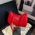 Red crocodile embossed underarm bag with gold metal bow buckle on black gift box - Red