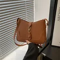 Chic caramel brown underarm shoulder bag with gold buckle and stylish u-shaped stitching - Brown