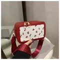 Red and white cherry print shoulder bag with wide strap and metallic dual zippers - Red