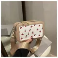 Beige square crossbody bag with cherry print, dual gold zippers, and wide strap - Khaki