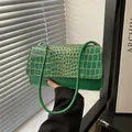 Chic emerald green croc-embossed shoulder bag with gold accents and smooth leather base - Green