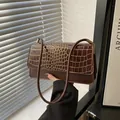 Dark brown faux crocodile skin shoulder bag with glossy finish and gold metal buckle - Brown