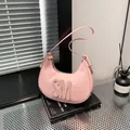 Pink crescent hobo bag with embossed SM logo and slim leather strap in casual style - Pink