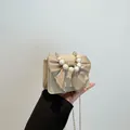 Elegant beige crossbody bag featuring a large satin bow and beaded pearl handle - Khaki