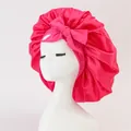 Detailed close-up of a rose red satin bonnet featuring a large bow and elastic edge - Medium / Rose Red