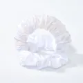 Nahaufnahme von zwei weißen Satin-Haargummis mit seidig glänzender Textur und Struktur - Weiß