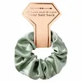 Detailed view of sage green silky satin scrunchie on decorative pink card packaging - Green