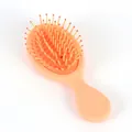 Mini brosse à cheveux pêche avec picots de massage et design compact et portable - Orange Mignon Mat