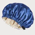Detail of royal blue satin sleep cap featuring adjustable black strap and buckle - Navy Blue + Beige