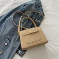 Elegant beige crossbody bag with cross-grain leather finish and gold twist lock closure - Khaki