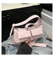 Detail of light pink padded nylon shoulder bag with front utility pockets and zipper - Pink