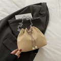 Bolso saco de paja tejida beige con cadena plateada y colgantes de perlas en el cordón - Caqui
