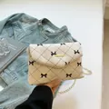 Off-white corduroy crossbody bag with black bow lattice pattern and gold chain strap - White Bow Style