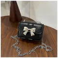 Cute black mini crossbody bag with silver metal bow and delicate chain strap for girls - Black
