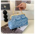 Detail of light blue sequined evening bag with golden metal handle and clasp closure - Blue