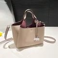 Beige pebble leather bucket bag with burgundy interior and stylish T-embossed detail - Khaki