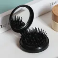 Tragbare faltbare Haarbürste mit Spiegel in schwarzem runden Design für Kopfmassage - Schwarze Schale Schwarzes Pad Schwarze Borsten