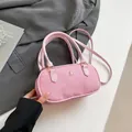 Pink canvas Boston bag with leather trim and gold logo in a stylish crossbody style - Pink