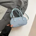 Light blue chic pillow bag with textured fabric, golden metal logo and crossbody strap - Blue