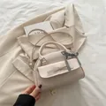 Creamy white bow handbag with black and white plaid ribbon and adjustable shoulder strap - White