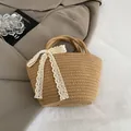 Handmade straw handbag with white lace bow detail for summer beach vacation style - Brown