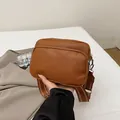Brown lychee leather crossbody bag with wide woven strap and double zippers - Brown