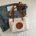 Beige tote bag with brown straps and leather patch on textured fabric background - Small / White Small Without Pendant