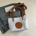 Light blue nylon tote bag with brown leather handles and adjustable shoulder strap - Small / Light Blue Small No Charm
