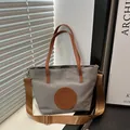 Gray tote bag with brown handles and a long shoulder strap on a simple desktop - Small / Light Gray Small No Charm