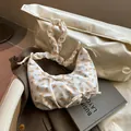 Floral crescent bag in cream with orange flower print and bow handle detail - Yellow Flower