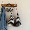 Large black and white striped canvas tote bag with a minimalist hobo design for summer - Black