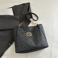 Black tote bag with M-monogram print, gold logo, and delicate chain shoulder strap - Black